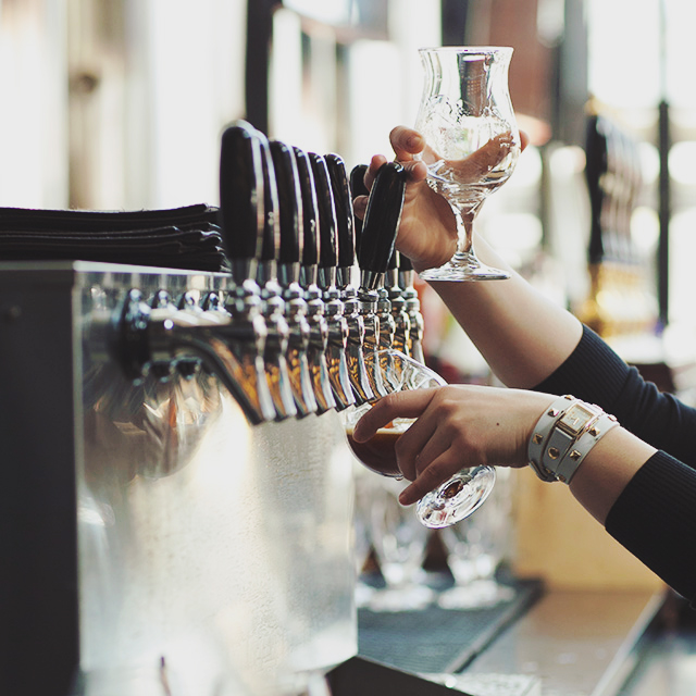 Woman pouring draft beers for tasting event at the Yards DC