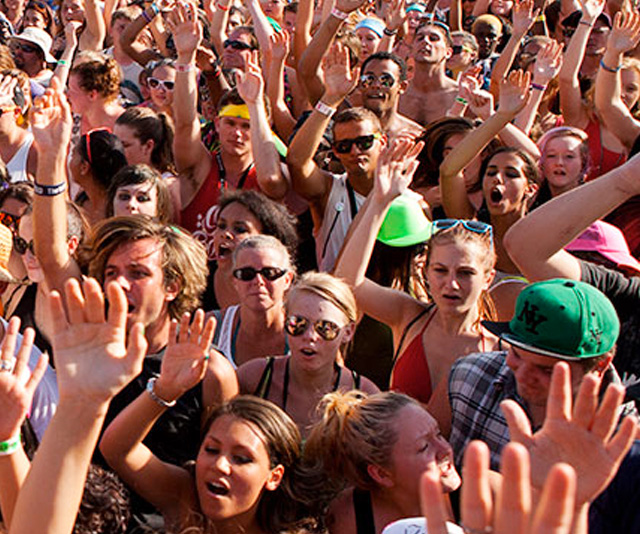 Large crowd with hands raised at a music and beer event in DC