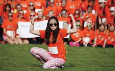 Woman posing in front of crowd at the walk for MS in DC