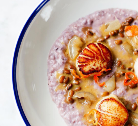 Upscale seafood dinner with scallops at a waterfront restaurant