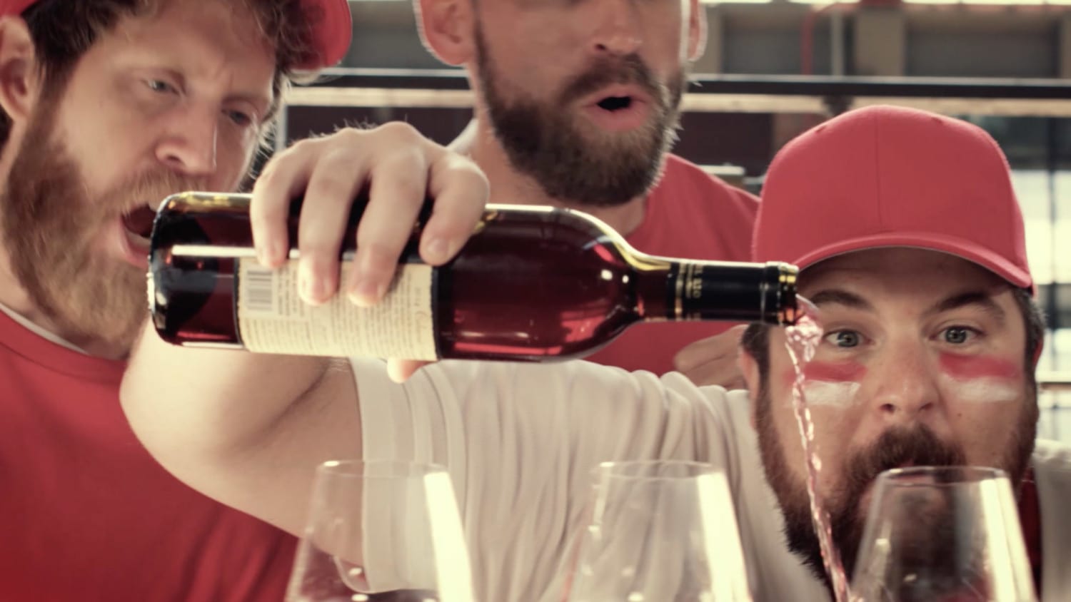 Fan in baseball gear pouring wine with friends