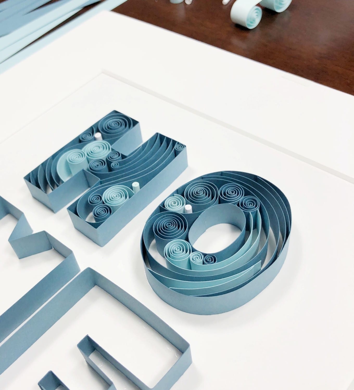 Paper quilling craft design that says "Home"