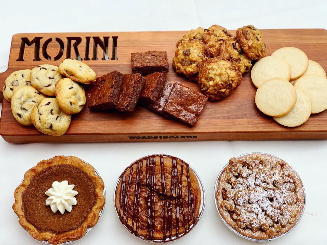 Multiple baked goods lying on a Morini cutting board