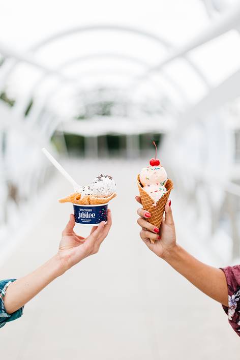 Hands holding ice cream cone and bowl from Ice Cream Jubilee