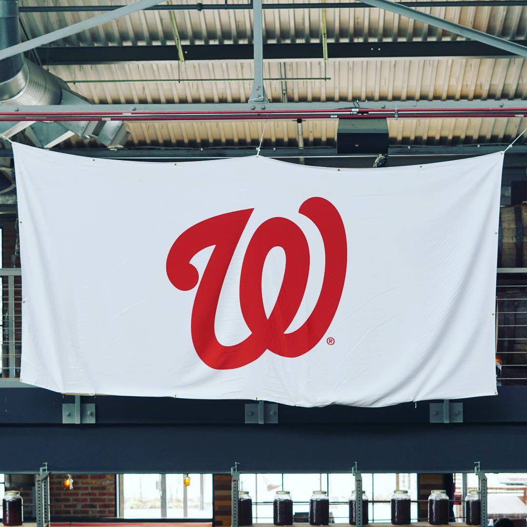 White Washington Nationals flag hanging from the rafters of a restaurant