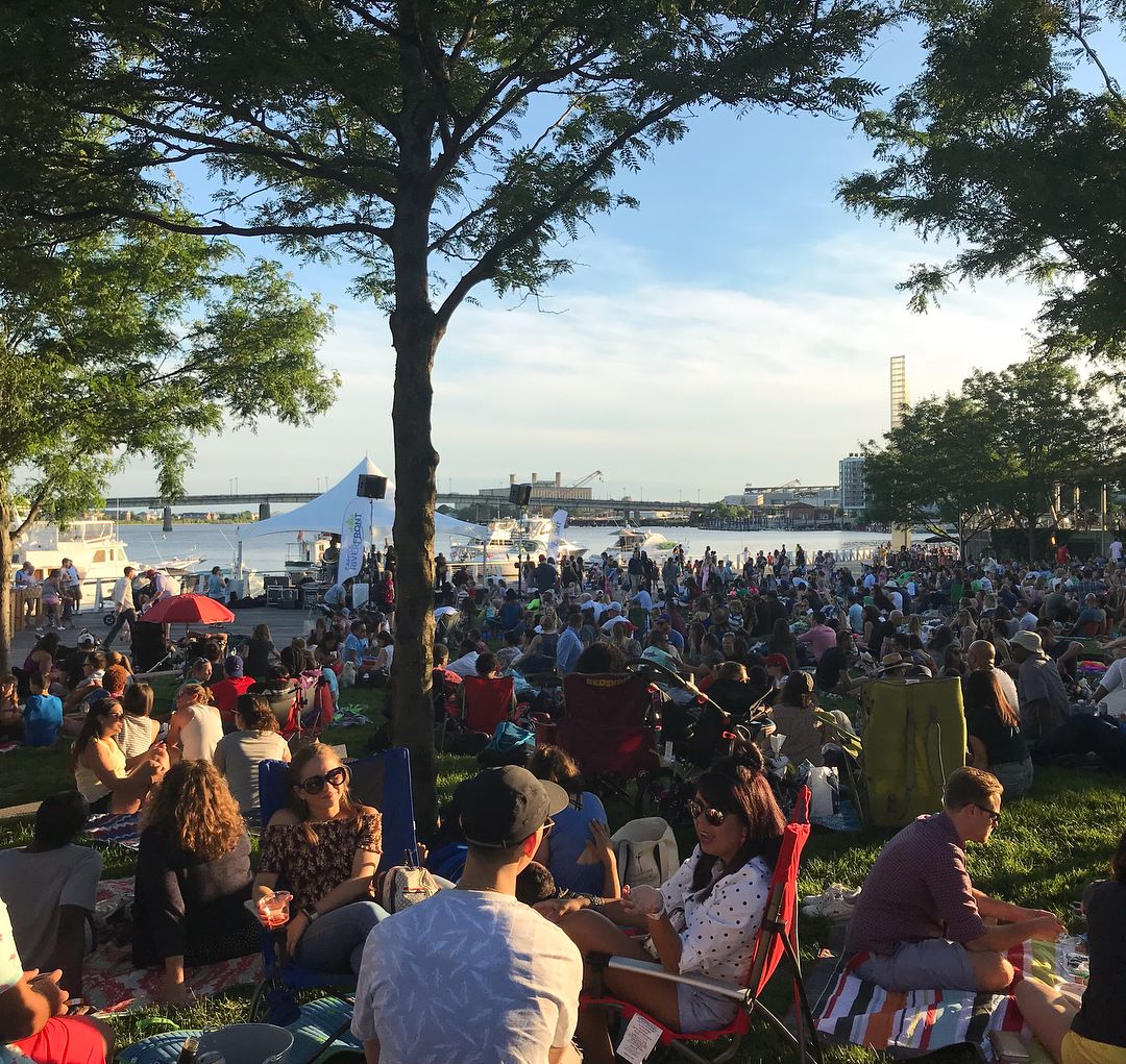 Crowded waterfront concert event in the summer at The Yards DC
