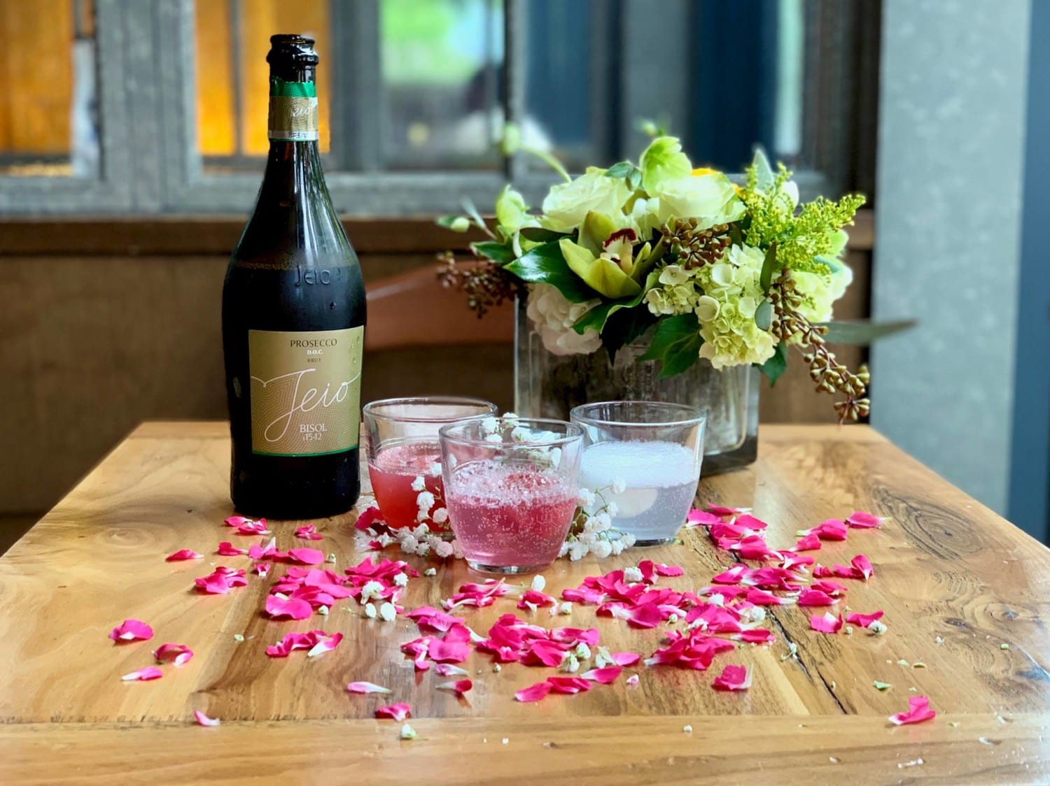 Glasses of rosé and prosecco with a bouquet of flowers at the Osteria Morini restaurant in Washington DC