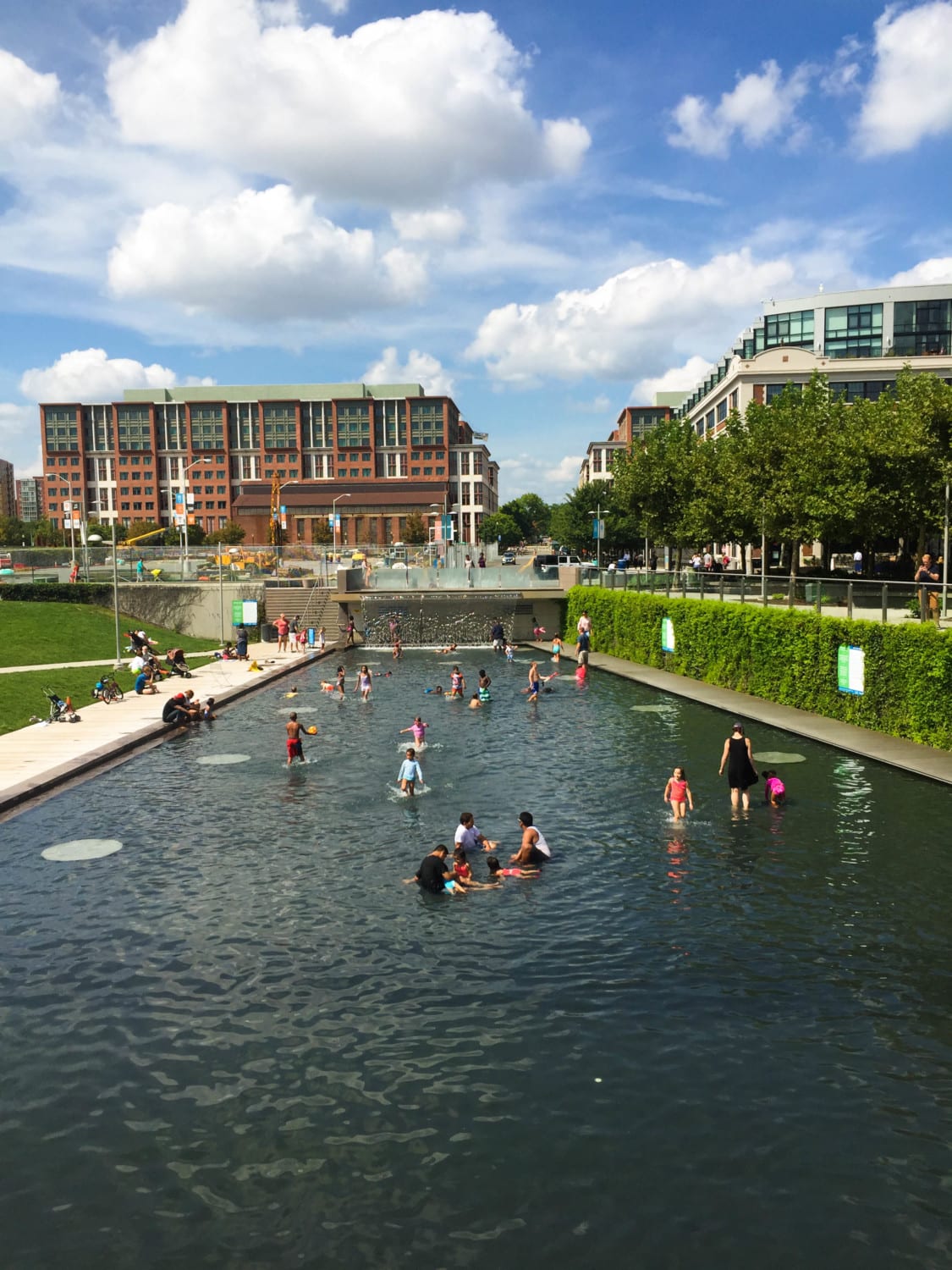 Families with children playing in the public fountain at The Yards DC